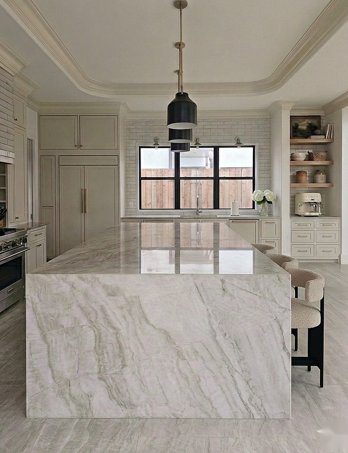 Custom kitchen with waterfall quartzite island by Chanda Custom Homes
